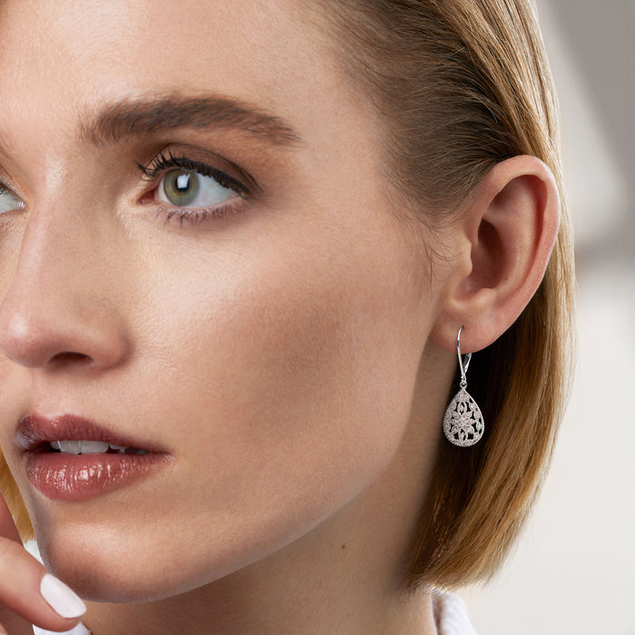 Sterling silver teardrop leverback earrings with openwork diamond-style pattern on ear