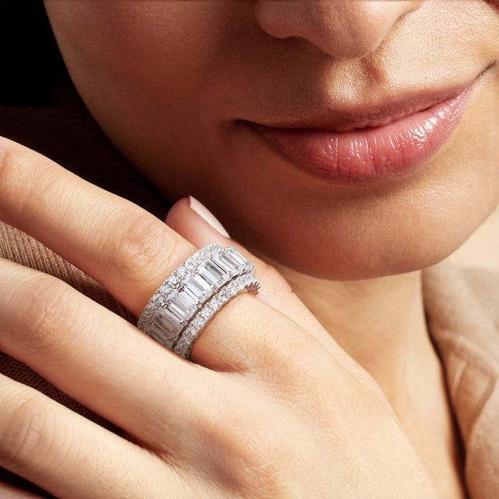 Sterling silver CZ eternity bands on hand, close-up with stacked rings