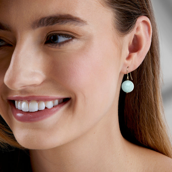 Round aquamarine-blue gemstone drop earrings on 14kt yellow gold earwires