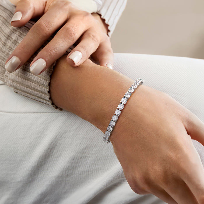 Sterling silver CZ tennis bracelet worn on wrist with oval stone line