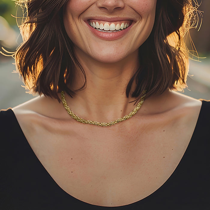 Gold-tone Byzantine chain necklace worn at the collarbone