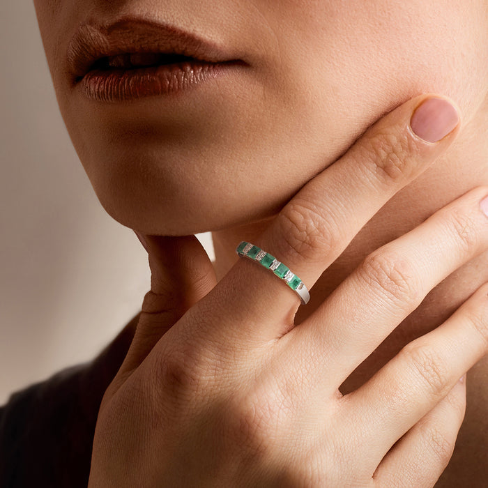 Sterling silver emerald and diamond ring on hand with green square stones
