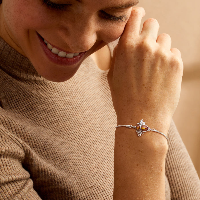 Sterling silver bolo bracelet with amber bumblebee charm worn on wrist
