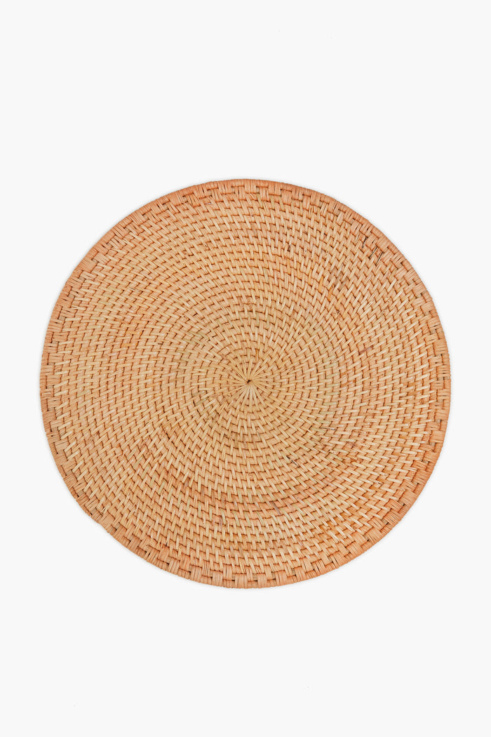The Caton's Wharf round placemat, made from woven rattan in a natural tan shade, brings organic charm to your table.