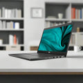 A black refurbished Dell Latitude 3420 (i5-1135G7, 32GB RAM, 512GB SSD, 14", Windows 11 Pro) is open at an angle with a teal abstract swirl on its screen. Side ports are visible and it's set against a plain white background.