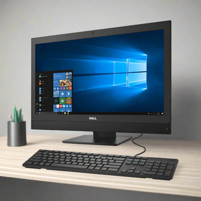 A Dell Optiplex 7450 AIO i5 7600 3.5GHz with 8GB RAM, 256GB SSD, and a 23" display runs Windows 10 Pro. It sits on a light wood desk with a black keyboard and wired mouse, ideal for updating your workspace.