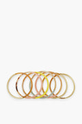 Six colorful bangles with gold accents, part of the Exclusive Sunset Bangle Stack by Sunshine Tienda x Ashley Brooke—artisan-crafted from cruelty-free buffalo horn.