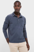 Young man models the Faded Navy Garment Dyed Long Sleeve Polo, exuding classic, effortless style with its soft Pima cotton and vintage look, embodying high-end comfort and fun versatility.