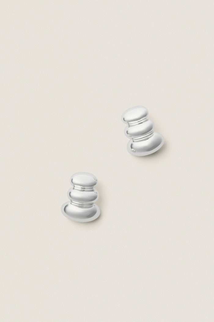 High Polish Silver Non-Stop Earrings feature classic, three-tiered, reflective forms. Effortless and bold, these fun, high-end pieces add drama and sophistication to any look.