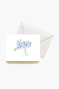 This Sara Fitz greeting card features a watercolor blue hydrangea in a glass jar on a white envelope—perfect for gifting with the Hydrangea Boxed Notes Set or as lovely stationery for any hostess gift.