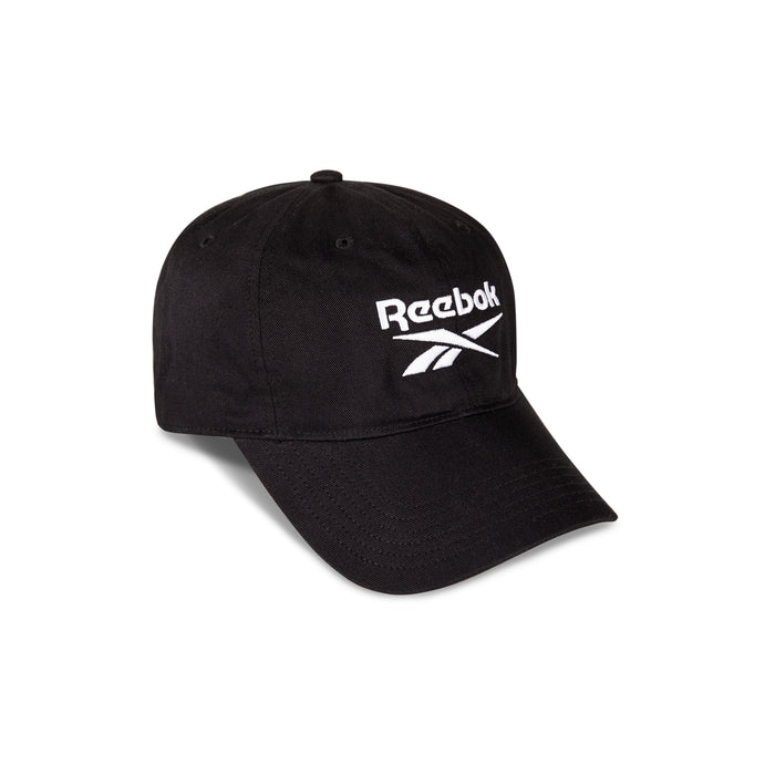 The Reebok Logo Cap is crafted from black cotton twill, featuring a curved brim, bold white embroidered logo and text on the front, and an adjustable buckle closure. Photographed against a white background.