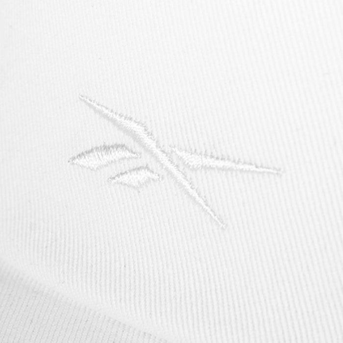 Close-up of a white cotton twill Reebok Logo S-Vector Cap, featuring a subtle, embroidered Reebok logo in matching white thread for a minimalist, textured look.