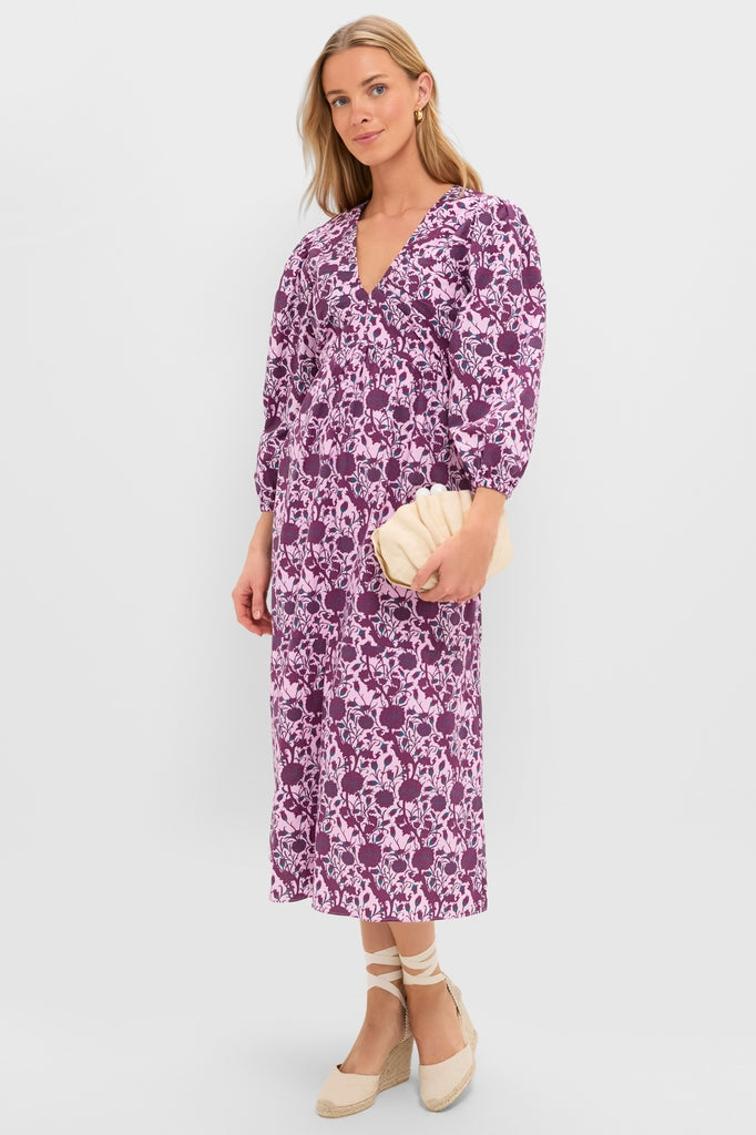 Model in a classic Mauve and Wine Floral Chloe Midi Dress, featuring an effortless V-neck, three-quarter sleeves, and empire waist, paired with fun espadrille wedges and a high-end clutch.