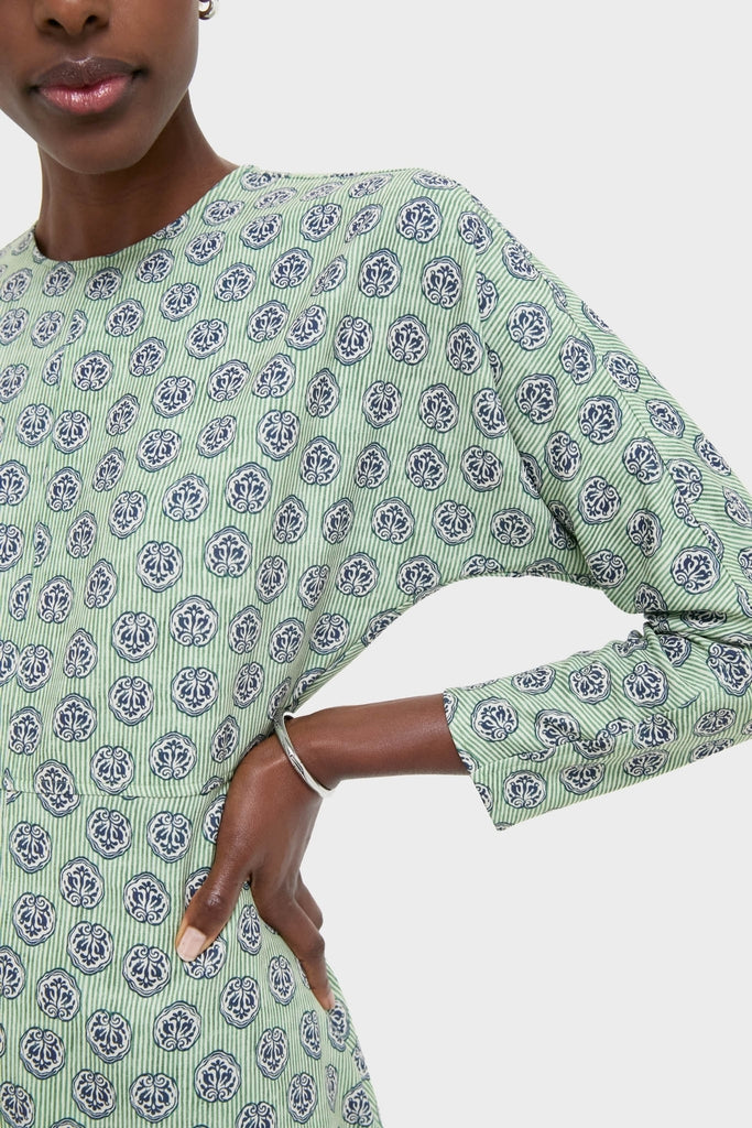 Model wearing the Navy Bird Block Vika Dress, featuring a classic light green design with navy-and-white motifs, three-quarter sleeves, and a modest neckline; an effortless, high-end choice.