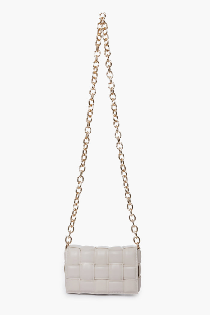 The Urban Expressions small rectangular white crossbody bag features a woven pattern, long gold chain strap, and is crafted from animal-friendly materials.