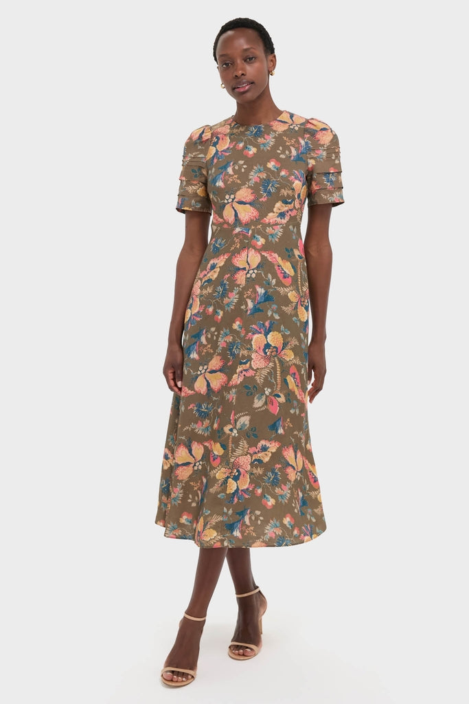 Olive Floral Casey Dress: A classic, effortless midi dress with puffed sleeves and an A-line skirt, featuring a fun, high-end floral print and nude ankle-strap sandals.
