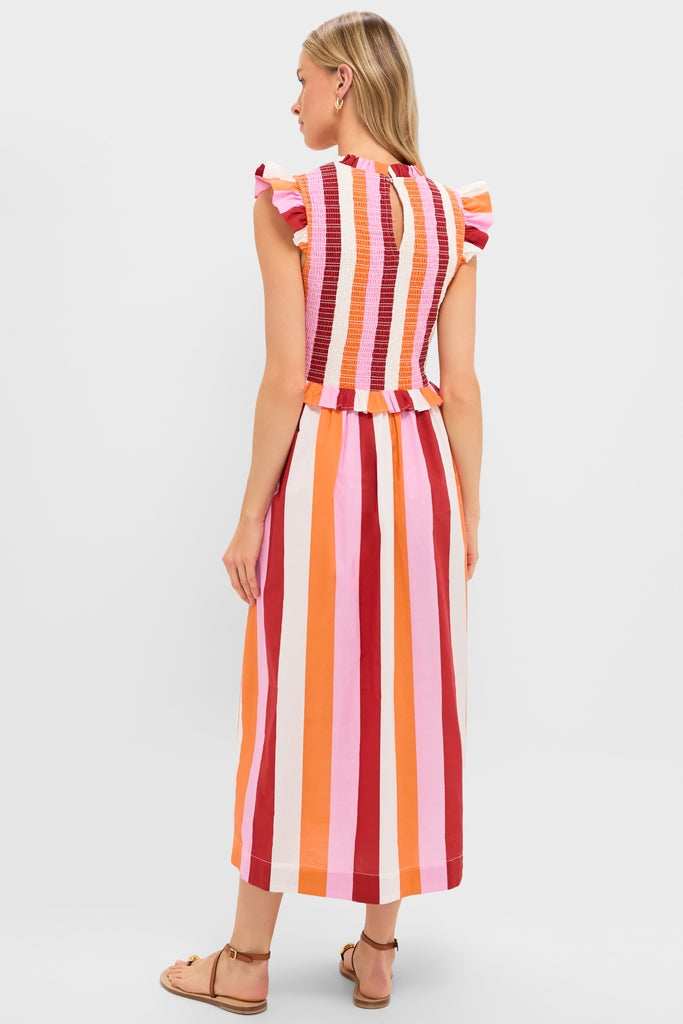 Back view of a woman in the classic, high-end Orange, Pink & Crimson Stripe Smocked Sully Dress, featuring an effortless smocked bodice and fun, ruffled details.