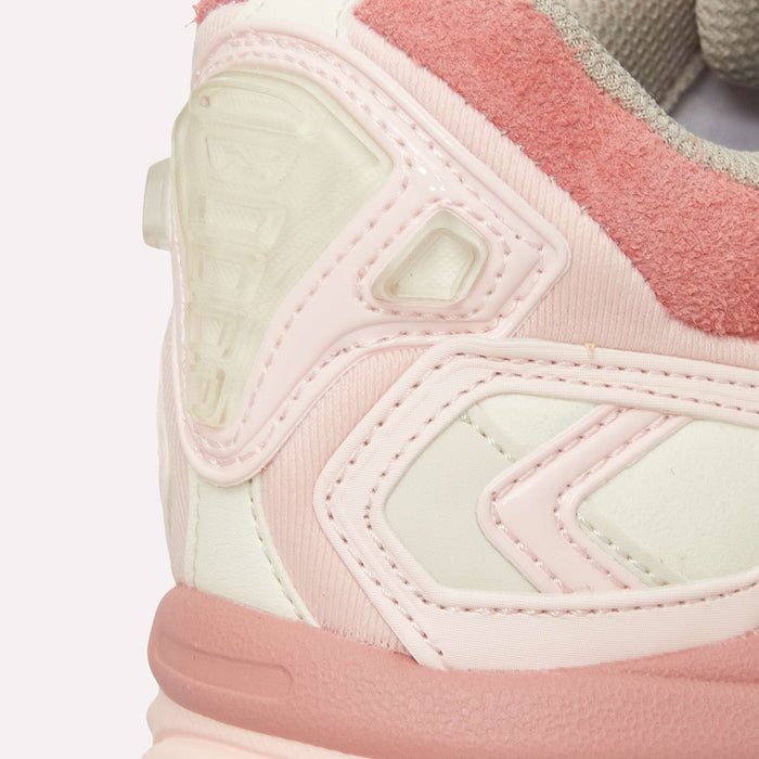 Close-up of the heel of the Reebok Premier Road Ultra LTD Shoes in pink and white, displaying detailed stitching, textured materials, and layered archival-inspired design elements. The dual-density midsole is visible, emphasizing both comfort and style.