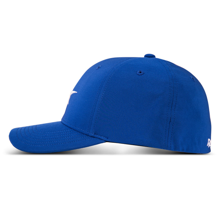 The Reebok Range Cap, shown from the side in blue, features a curved brim, visible stitching, a small white back logo, and moisture-wicking fabric to keep you cool and comfortable on the golf course.