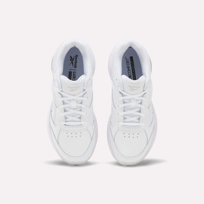 A pair of Women’s DMX Comfort + Walk Ultra Shoes by Reebok in white, viewed from above to showcase the laces, perforated toe detailing, and Reebok branding on the tongue and insole—all set against a plain light background. These walking shoes are enhanced with DMX Comfort+ cushioning for all-day comfort.
