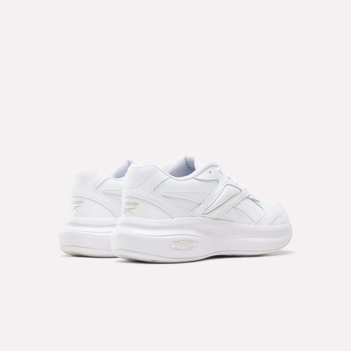A pair of Reebok Women’s DMX Comfort + Walk Ultra Shoes in white, featuring thick soles and advanced DMX Comfort+ cushioning for superior support, shown from the back and side against a plain light background—ideal women’s walking shoes for all-day comfort.